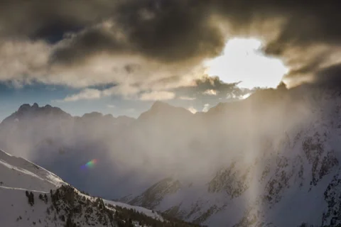 Snow covered mountain peaks clouds and sun Tirol Ischgl 4.8K Stock Footage 35738069