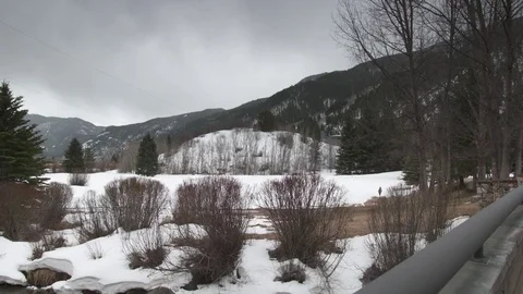 Snow covered mountain with pine tree and flowing water during winter Stock Footage 84505687