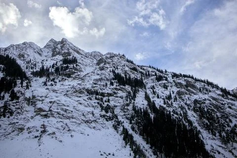 Snow-Covered Mountain with Pine Trees, Dramatic Cumulus Clouds, Kalam, Pakistan Stock Photos