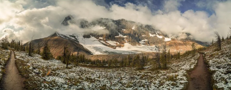 A snow covered mountain range with a clear blue sky Stock Photos
