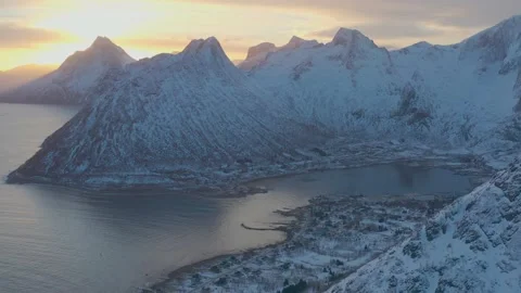 Snow covered mountain range on coastline in winter, Norway. Senja Stock Footage 234324757
