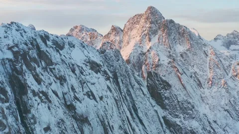 Snow covered mountain range on coastline in winter, Norway. Senja Stock Footage 234329790