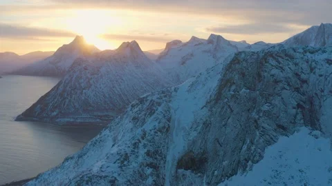 Snow covered mountain range on coastline in winter, Norway. Senja Stock Footage 234430088