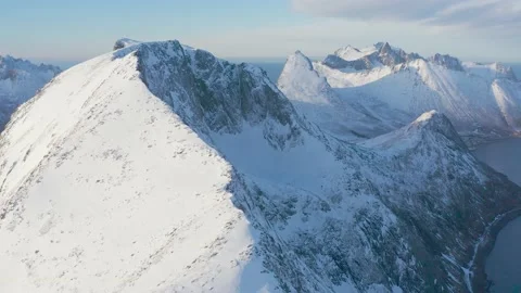 Snow covered mountain range on coastline in winter, Norway. Senja 스톡 동영상 234437892