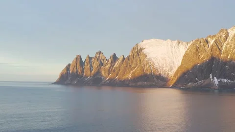 Snow covered mountain range on coastline in winter, Norway. Senja Stock Footage 234444026
