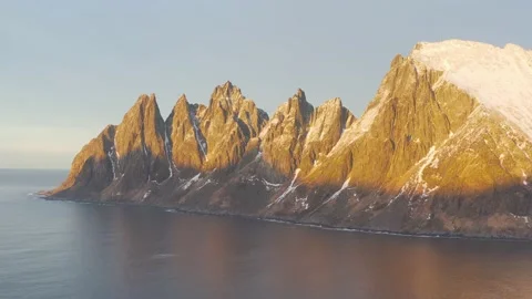 Snow covered mountain range on coastline in winter, Norway. Senja Stock Footage 234548754
