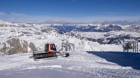Snow-Covered Mountain Range with Red Snowcat in Foreground Stock Photos