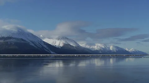 Snow Covered Mountain Range Reflected in Calm Water Stock Footage 38079883