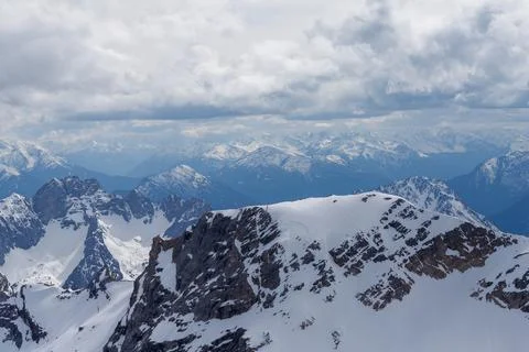 Snow-Covered Mountain Range Under Cloudy Sky Stock Photos