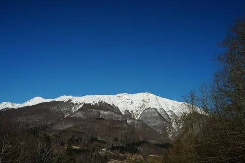 Snow-Covered Mountain Range under Clear Blue Sky Stock Photos