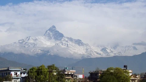 Snow covered mountain ranges and a Nepalese town Stock Footage 113255396