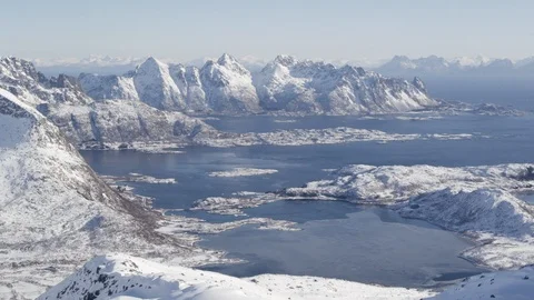 Snow covered mountain ranges around an icy water Stock Footage 113228620