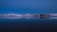 Snow Covered Mountain Ranges Being Reflected In The Lake At Evening Stock Footage