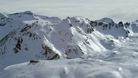 Snow covered mountain ranges on a sunny day Stock Footage 116788151