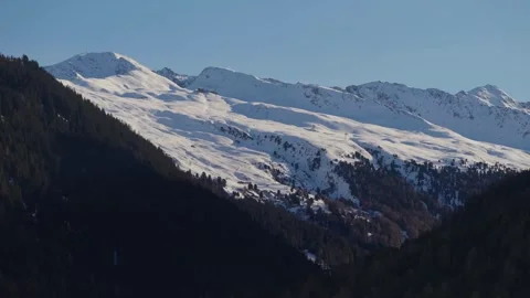 A snow-covered mountain ridge above the Davos valley Stock Footage 345299355