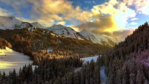 Snow covered mountain with sunset in drone shot	 Stock Footage 252435527