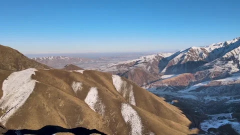 Snow Covered Mountain Terrain in Chunkurchak Gorge, Kyrgyzstan Stock Footage 338332449