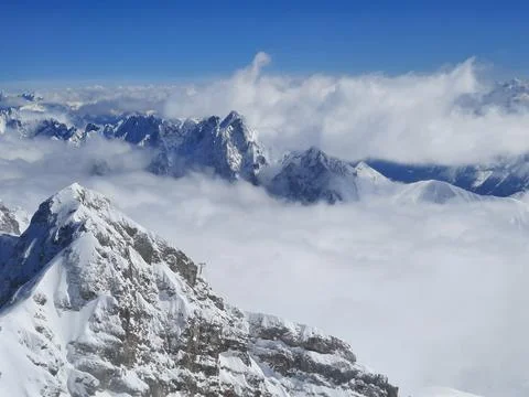 Snow covered mountain top in Austria. View of the Alps from the Zugspitze, the Stock Photos