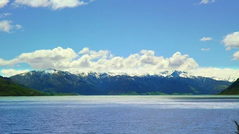 Snow covered mountain tops at the border of Lake Hawea Stock Footage 85492588