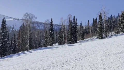 A snow-covered mountain winter forest with a ski lift at a ski resort. Video stock 321563151