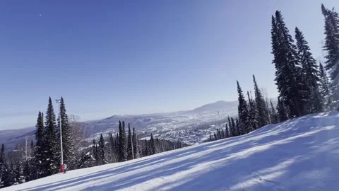 A snow-covered mountain winter forest with a ski lift at a ski resort. Видео 321563170