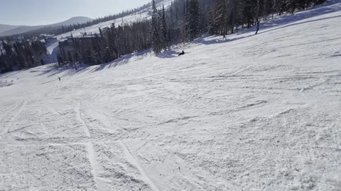 A snow-covered mountain winter forest with a ski lift at a ski resort. Видео 321563204