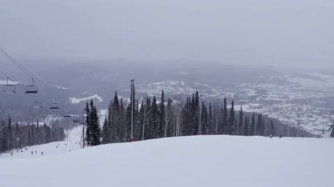A snow-covered mountain winter forest with a ski lift at a ski resort. Stock-Footage 321564398