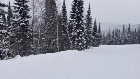 A snow-covered mountain winter forest with a ski lift at a ski resort. Stock-Footage 321564410