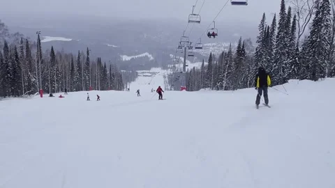 A snow-covered mountain winter forest with a ski lift at a ski resort. Stock-Footage 321564440