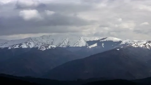 Snow Covered Mountains And Clouds Time lapse Stock Footage 234081844
