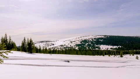 Snow covered mountains in a blue cloudy sky winter day Stock Footage 172207376
