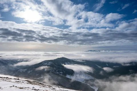 Snow covered mountains with clouds and mist in valley, Low Tatras Dumbier, Sl Stock Photos