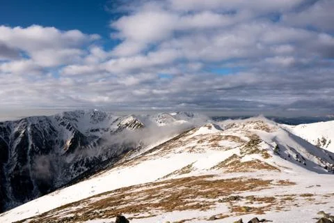 Snow covered mountains with clouds and mist in valley, Low Tatras Dumbier, Sl Stock Photos
