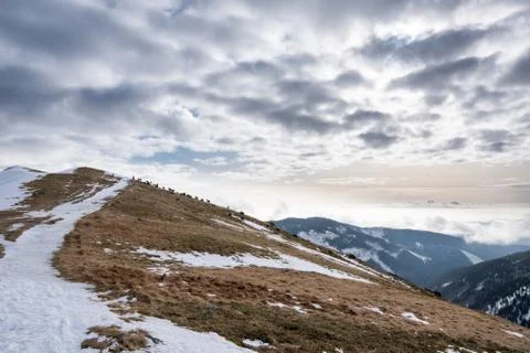 Snow covered mountains with clouds and mist in valley, Low Tatras Dumbier, Sl Stock Photos
