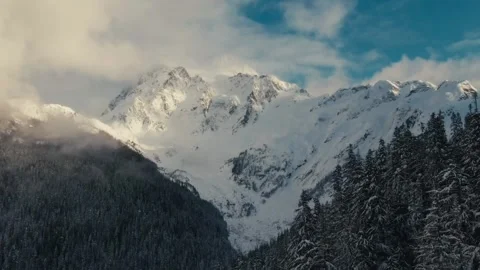 Snow-covered mountains reflect sunlight in stunning landscape view Stock Footage 320293337