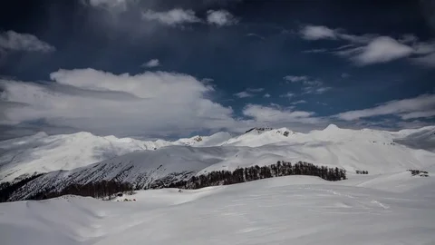 Snow covered Mountains. Shadows moving.  Wide fast Clouds Stock-Footage 83692848