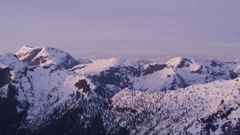 Snow-covered mountains shine under the morning light Stock Footage 320293436