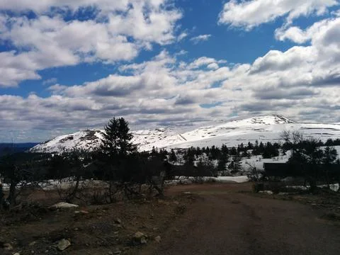Snow covered mountains in the spring Stock Photos