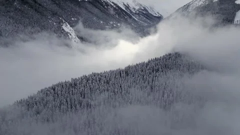 Snow-covered mountains surrounded by mist Stock Footage 297188155