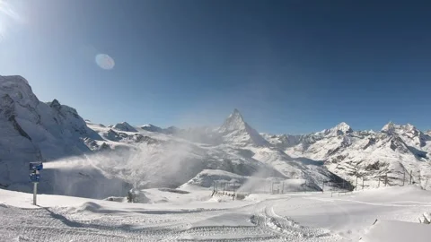 Snow-Covered Mountains Under Bright Blue Sky Stock Footage 314786873
