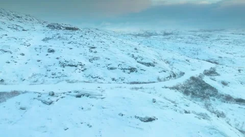 Snow-covered mountains under a cloudy sky at Musta - Tunturi Ridge, Kola Peninsu Stock Footage 308951284