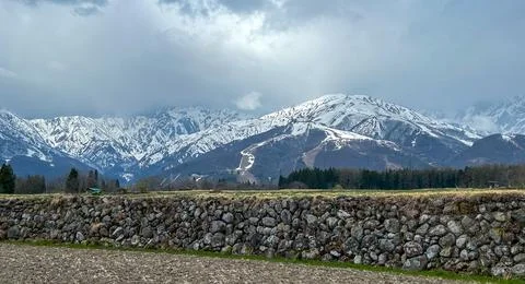 Snow-Covered Mountains Under Cloudy Sky. Stock Photos