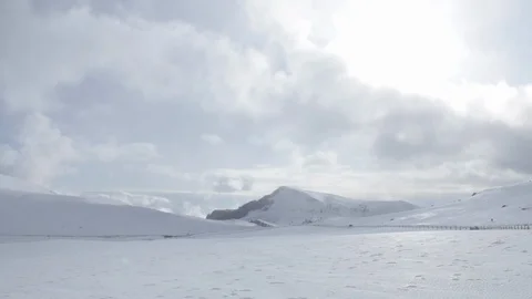 Snow covered mountains in winter, sun and clouds Stock Footage 128260645