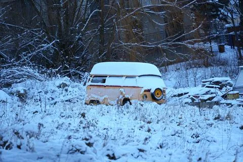 Snow covered old beige van. Stock Photos