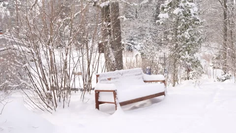 Snow Covered Park Bench. Winter Scene With Snow Falling at Night Stock Footage 285750412
