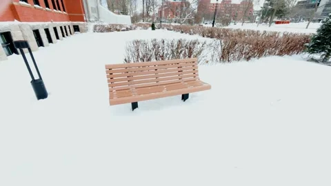 Snow Covered Park Bench in Winter Landscape Stock Footage 323487150