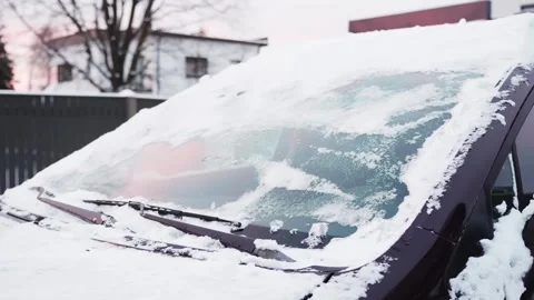 Snow-covered parked car with windshield wipers frozen into ice after sleet and Stock-Footage 327521168