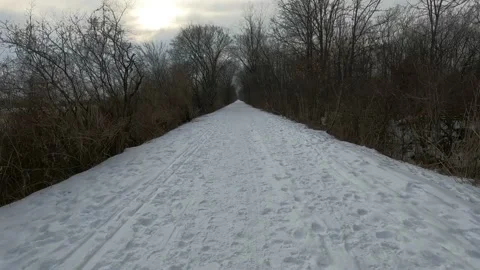 Snow covered path POV moving forward Stock Footage 148948571