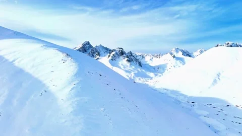 Snow-Covered Peaks Under Deep Blue Skies Video stock 314298449