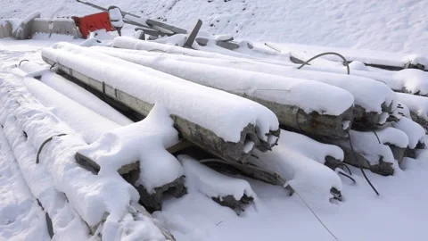 Snow-covered piles of pillars on the ground. Stock Footage 158908325